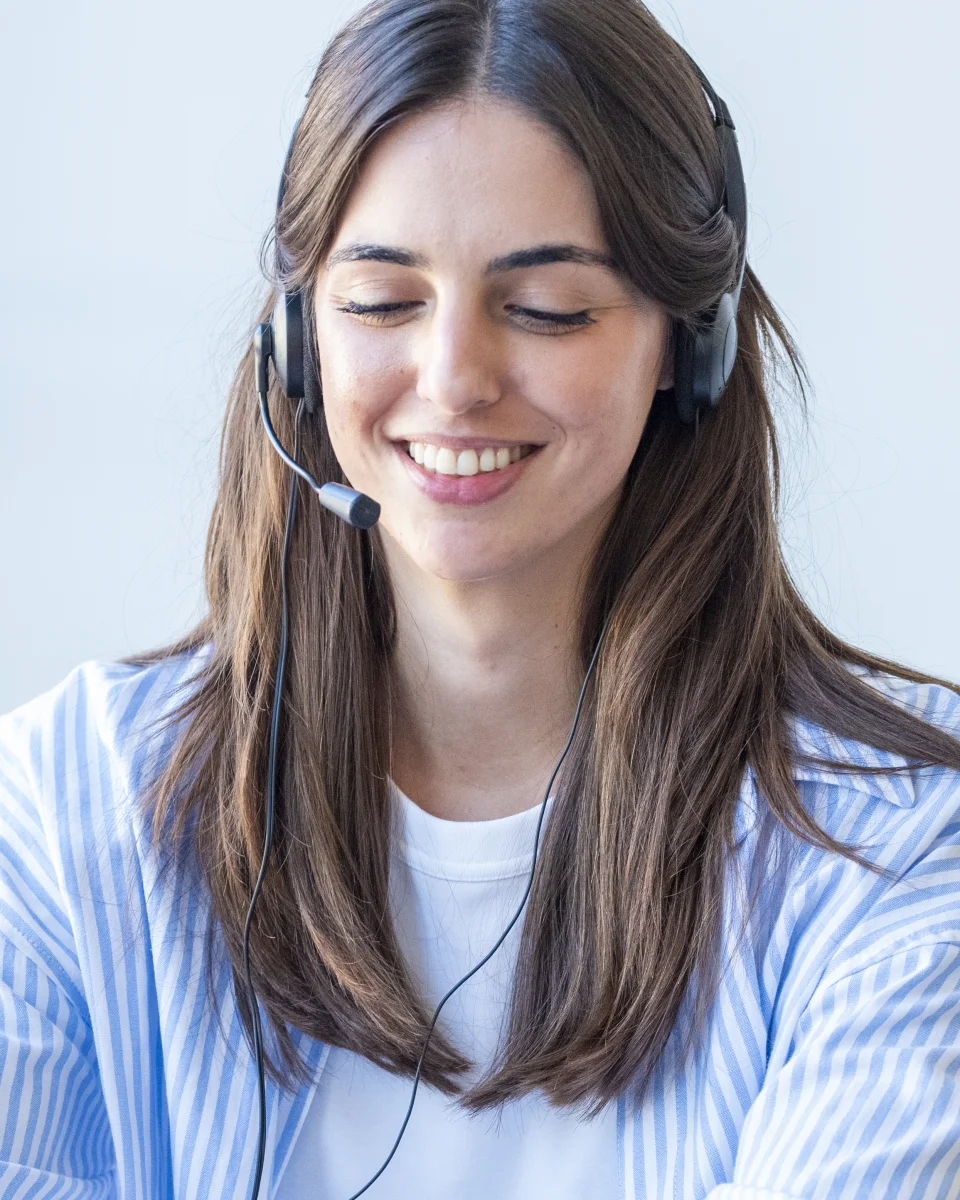 A smiling customer support specialist wearing a headset