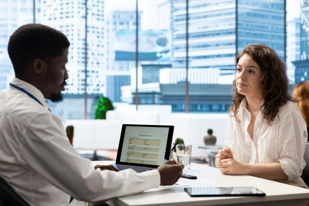 A recruiter meeting with a candidate in a modern office